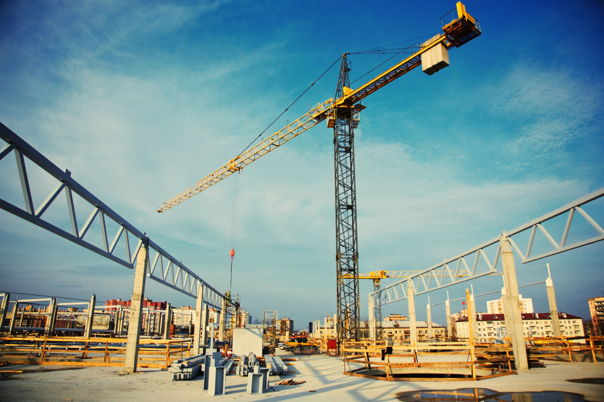 Large Construction Site with Crane Against Blue Sky