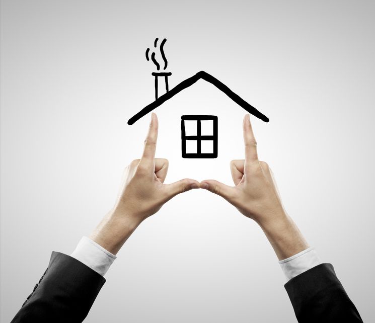 A drawing of a house and a man's hands creating the sides of the house