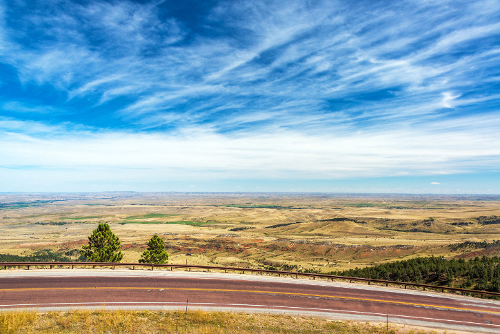 View of a highway with a beautiful landscape and dramatic sky near Sheridan, Wyoming