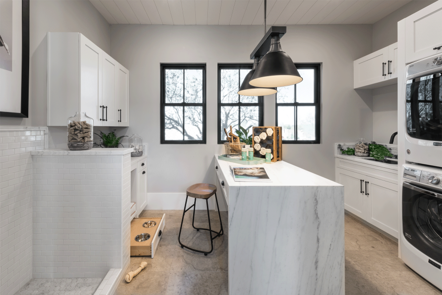 A very modern room, with a washer and dryer in it.  