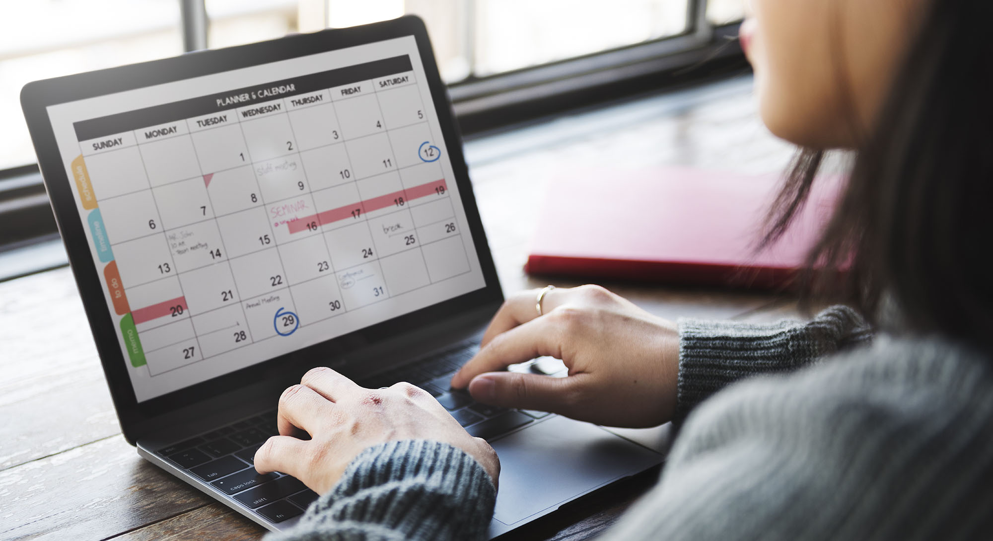 Woman viewing a calendar application on a laptop